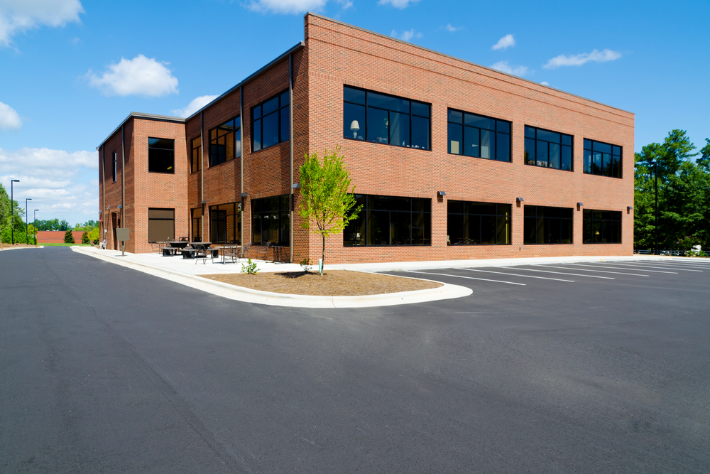 View of Brick Office and Large Parking Lot